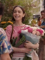 Emily Cooper in a vibrant red geometric print top from her Parisian wardrobe.
