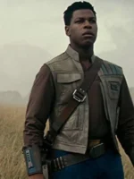 John Boyega wearing a beige leather vest with red detailing from the Star Wars films.
