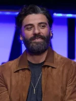 Oscar Isaac wearing a rich brown suede jacket with a smart collar and front zipper.