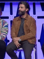 A close-up of a premium brown suede jacket with a zip-up front as seen on Oscar Isaac.