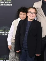 A young boy wearing a neat black blazer inspired by Robert Timothy Smith in Star Wars: Skeleton Crew.