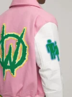 Close-up view of various logos and patches on the pink varsity jacket mens style.