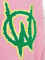 Close-up of the large patch on the back of the pink and white varsity jacket.