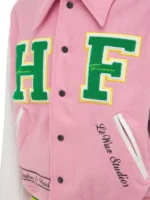 Close-up front view of the pink letterman jacket with snap buttons.