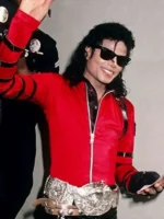 Detailed view of the multiple adjustable silver buckle straps on the red satin jacket sleeves.