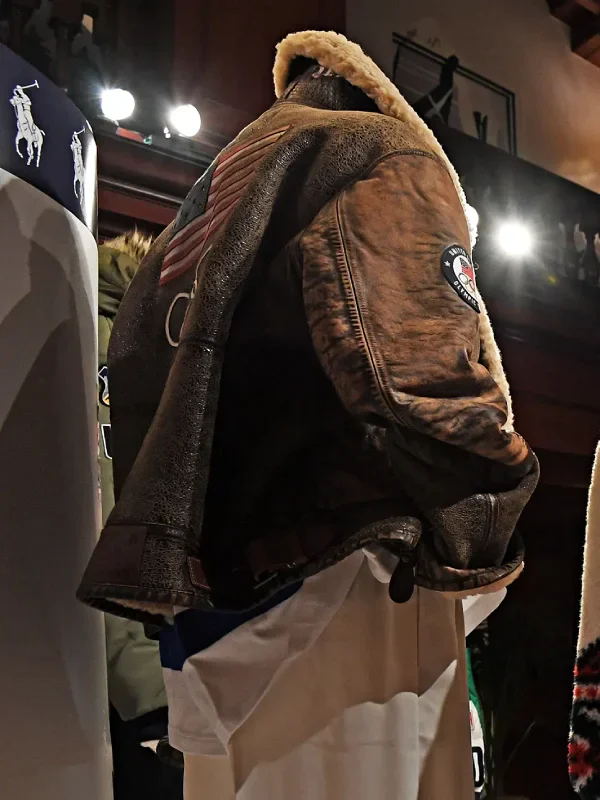 The back of the 2026 Team USA brown leather jacket showing the large stars-and-stripes patch and branding.