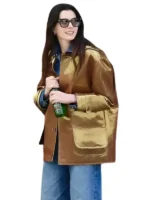 Anne Hathaway gold metallic barn jacket styled with jeans and a denim shirt.