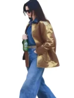 Close-up of the front pockets and buttons on the Anne Hathaway gold barn jacket.