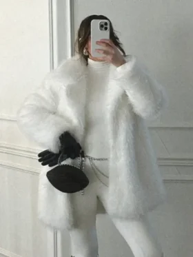 Front view open closure of Kennedy Stidham white vegan fur coat showing relaxed drape, mid-length fit, and cozy winter styling.