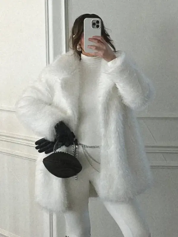 Kennedy Stidham White Vegan Fur Coat Front View Open Closure Front view open closure of Kennedy Stidham white vegan fur coat showing relaxed drape, mid-length fit, and cozy winter styling.