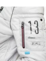 Close-up of the silver zipper and padded white fabric on the puffer jacket from TV Jackets.