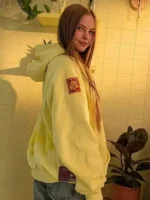 Side view of the yellow Salish Matter hoodie focusing on the high-quality embroidered patch on the sleeve.