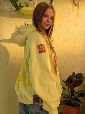 Side view of the yellow Salish Matter hoodie focusing on the high-quality embroidered patch on the sleeve.