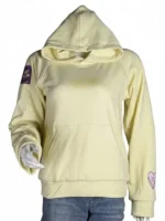 A young girl smiling while wearing a bright butter yellow "Sincerely Yours" oversized pullover hoodie.