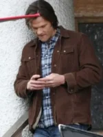 Brown Trucker Jacket side profile highlighting the precise sleeve stitching and adjustable waist tabs.