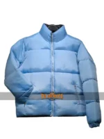 Studio shot of the Andy Cohen blue puffer jacket on a hanger, showcasing the stand-up collar.