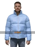 Full front view of a male model wearing the Andy Cohen New Year's blue puffer jacket.