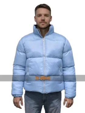 Full front view of a male model wearing the Andy Cohen New Year's blue puffer jacket.