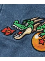 The blue denim sherpa jacket breeze x dragon ball edition, laid out to show the full silhouette.