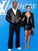 Didier Drogba styling the black hooded leather jacket with a white shirt and black trousers.