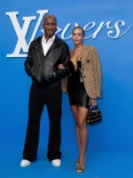 Didier Drogba in a black hooded leather jacket alongside Gabrielle Lemaire in Paris.