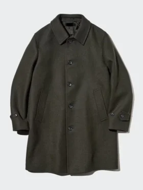 Close-up view of the olive Balmacaan coat collar and raglan sleeve stitching.