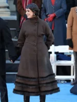 Styling view of the Rama Duwaji chocolate brown coat with faux fur trim.