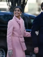 Side walking shot of Usha Vance pink inauguration coat showing long hem flow, belted waist, and elegant winter styling.