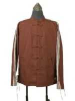 A studio product shot of a male model wearing the full-zip Adidas x CLOT Chinese New Year track jacket in Fox Brown, featuring a mandarin collar with traditional white frog closures over a silver zipper and white rope three-stripes down the sleeves.