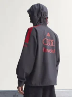 The back view of the black Adidas x Audi F1 mechanics jacket displaying the streamlined cinematic silhouette mapping.