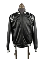 Front view of the black satin Keith Powers The Gates flight jacket on a vintage tailoring mannequin, highlighting the high-luster fabric, central chrome zipper, snap-button flap accents, and distinct striped rib-knit details.