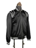 Three-quarter side view of the black satin Keith Powers jacket, highlighting the structured welt hand pocket entry, sleeve alignment, and detailed striped knit texture.