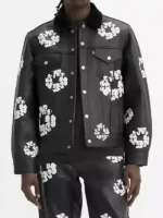 A full-length view of the black Levi’s x Denim Tears leather jacket featuring the signature white cotton wreath print.