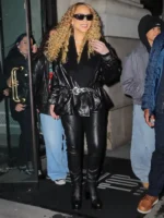 Close-up of Mariah Carey Phoebe Philo black leather jacket highlighting the adjustable belted cuffs and rich grain.