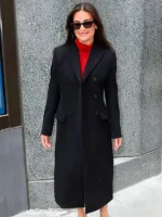 Lea Michele wearing the black wool coat in a 2026 NYC street style setting.