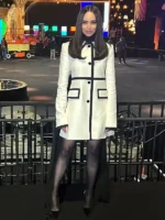 Close-up of the Sofia Carson inspired white wool dress featuring black velvet trims and round neckline.