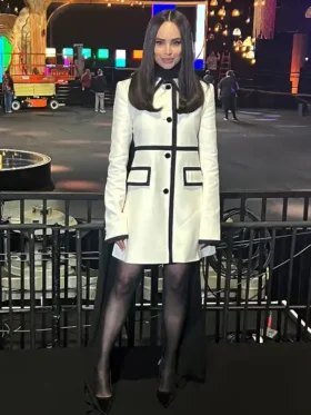 Close-up of the Sofia Carson inspired white wool dress featuring black velvet trims and round neckline.