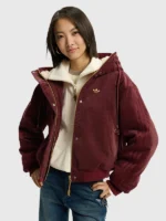 A model showing the unisex fit of the Adidas 2026 Lunar New Year hooded jacket.