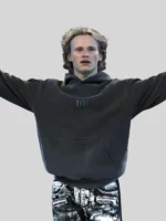 Lifestyle shot of the oversized grey NF Fear hoodie in an urban setting.