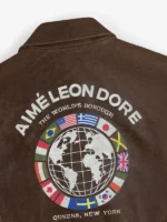 Close-up of the textured brown leather on the ALD Worlds Borough jacket showing cinematic grain.