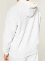 Lifestyle image of the Light Heather Grey reversible hoodie in a relaxed setting.