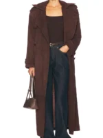 A view of the oversized cuffs and military styling on the brown suede trench coat.