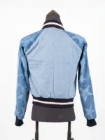 Full rear presentation of the Adidas Denim Graphic Varsity Bomber Jacket displaying a light-wash back torso and dark-wash star-printed sleeves.