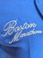 Close-up of marathon varsity jacket button closure and cuffs.