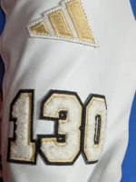 Back view of blue varsity jacket with marathon embroidery.