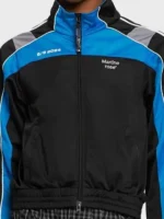 Close-up detail of the Martine Rose S/S 2024 branding and zipper on the track jacket.