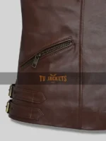 Close-up of zip pocket and buckle belted hemline on Grace Ashcroft brown leather jacket