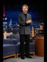 Full-length shot of Ryan Gosling's Project Hail Mary press tour outfit featuring a grey double breasted wool coat and black trousers.