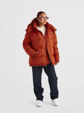 The front profile of the 1920 Orange Puffer Jacket showcasing the robust zipper and balanced silhouette.