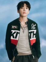 Jungkook in black Kith zip-up varsity knit jacket with red white colorblock panels and KITH branding at BTS Swimside 2026